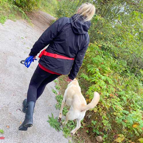 Woman walking dog on SniffSpot trail